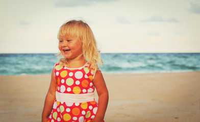 happy little girl play on beach