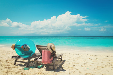 Fototapeta na wymiar Two beach chairs on tropical vacation