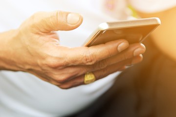 A man using smartphone in his hand.