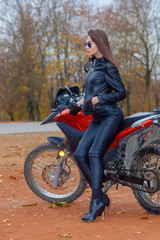 Portrait of a beautiful hipster girl on a sports motorcycle