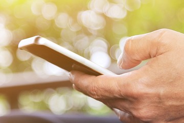 A man using smartphone in the garden,Outdoor working concept.