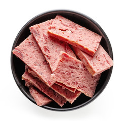 Bowl of sliced ham isolated on white; from above