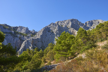 Fototapeta na wymiar Rocks and mountains of Hvar island. Hvar island is popular touristic destination at Croatian coast.