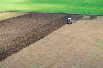 Obraz premium Tractor plowing field
