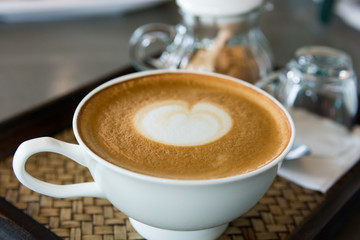 cappuccino cup of coffee on wooden table