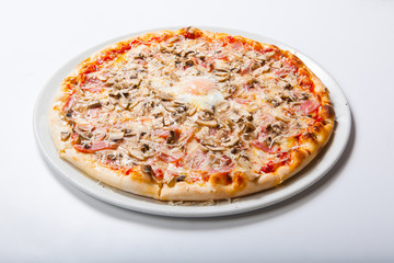 Italy pizza with egg yolk ham mushrooms on a white background