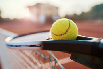 Tennis ball with racket on the tennis court. Sport, recreation concept