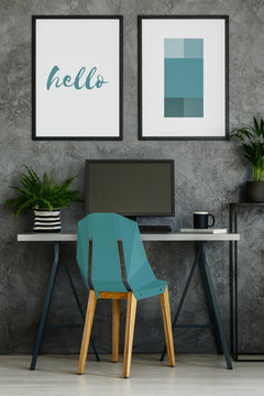 Turquoise chair in gray interior