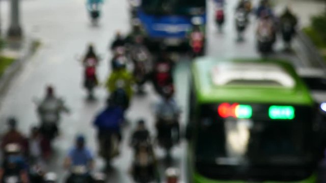 HO CHI MINH, VIETNAM - MARCH 18 2017: Out focus. Rush hour, traffic sound. Thousands of motorcycles and car crowd the streets of Ho Chi Minh City also known as Saigon, the largest city in Vietnam.