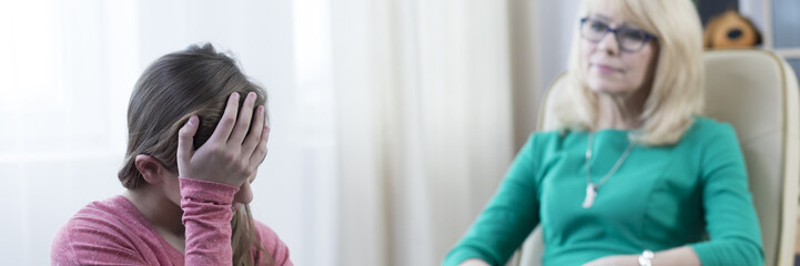 Girl holding head in hands