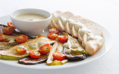 roasted vegetables and chicken breast slices with cream mustard sauce