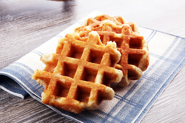 Traditional belgian waffles on brown wooden board