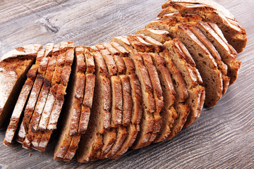 freshly baked bread on wooden board. cutted bread