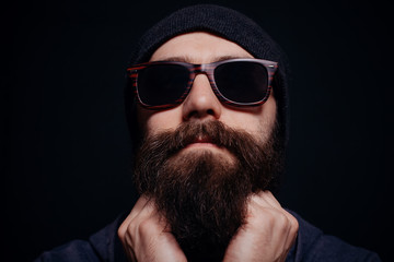 Handsome male big beard in glasses and hat