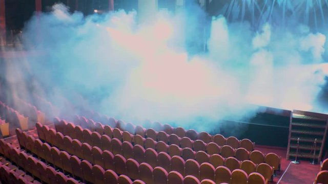 View of patio seats and stage in the background with smoke bomb running