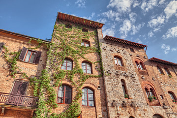 Fototapeta na wymiar San Gimignano, Siena, Tuscany, Italy: ancient buildings in the old town