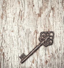 Vintage background with old key on wood