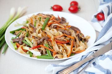 Wok. Noodles with meat and vegetables in Chinese