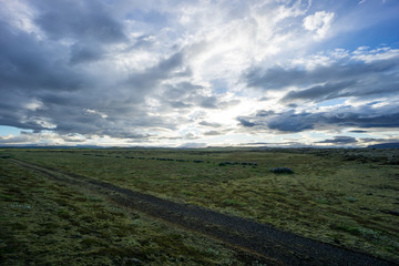 Iceland - Wide green landscape with intense cloud formation at dawn