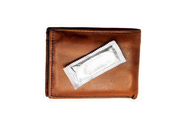 One condom in brown leather wallet on white
