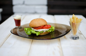 Hamburger with fresh lettuce and eggs. French fry