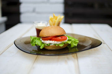 Hamburger with fresh lettuce and eggs. French fry