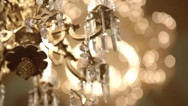 Interior of the old castle or theatre. Beautiful gallant large chandeliers with light candles and dark side background in the theatre.
