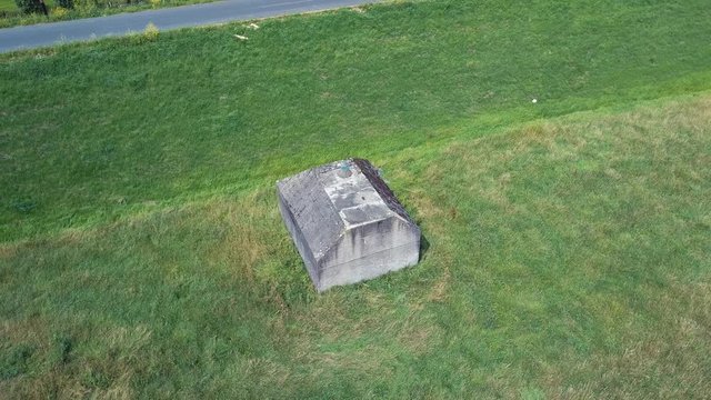 Aerial of old shelter bunkers from world war two in the middle of a meadow near Culemborg, the Netherlands &ndash; 4K