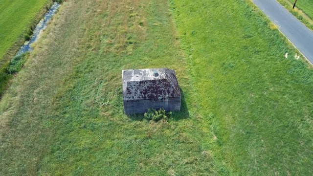 Aerial of old shelter bunkers from world war two in the middle of a meadow near Culemborg, the Netherlands &ndash; 4K