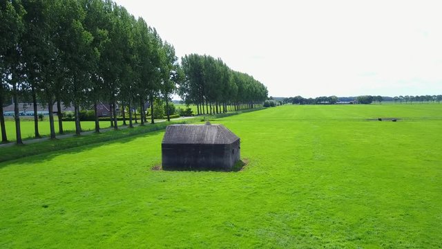 Aerial of old shelter bunkers from world war two in the middle of a meadow near Culemborg, the Netherlands &ndash; 4K