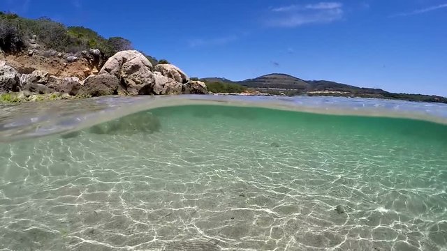 Split underwater view of Alghero shoreline. Sardinia, Italy