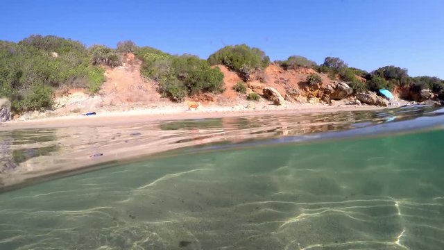 Split underwater view of Alghero shoreline. Sardinia, Italy