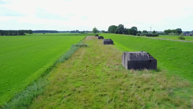 Aerial of old shelter bunkers from world war two in the middle of a meadow near Culemborg, the Netherlands &ndash; 4K