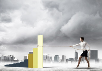 Businesswoman pulling arrow with rope and making it raise up