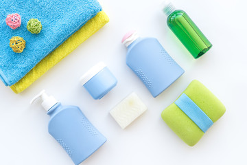 Bath accessories. Towels, soap, shampoo, lotion, cream on white background top view