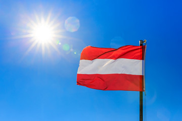 Fototapeta na wymiar Austrian flag and clear blue sky