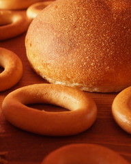 Bread and roll on a wooden table in the form of the sun