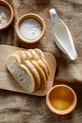 Homemade bread. Slices and ngredients on canvas background top view