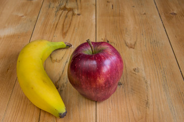 Banana nad apple on wood