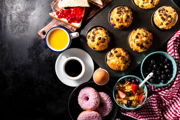 Tasty fresh breakfast food ingredients on black dark background. Ready to cook. Home Healthy Food Cooking Concept.