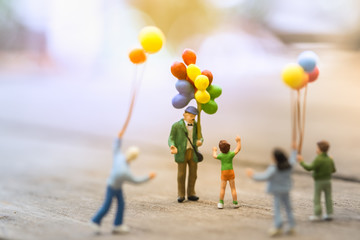 Family and kid concept. Group of children miniature people figure standing and walking around a man...