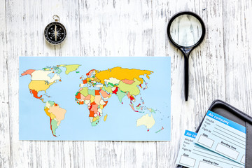 Search and buy tickets for travel. Tickets and world map on light wooden table background top view
