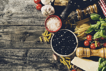 Obraz na płótnie Canvas Tasty fresh appetizing italian food ingredients on old rustic wooden background. Ready to cook. Home Italian Healthy Food Cooking Concept. Toning.