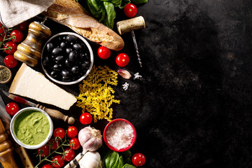 Tasty fresh appetizing italian food ingredients on dark background. Ready to cook. Home Italian Healthy Food Cooking Concept. Toning.