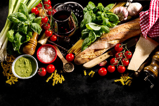 Tasty fresh appetizing italian food ingredients on dark background. Ready to cook. Home Italian Healthy Food Cooking Concept. Toning. - Powered by Adobe
