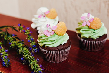 Beautiful and tasty muffins with raspberries and flowers	