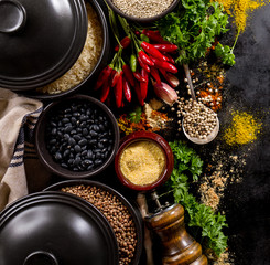 Beautiful Tasty Appetizing Ingredients Spices Grocery for Cooking Healthy Kitchen. Dark Black Background Top View. Flat Lay.