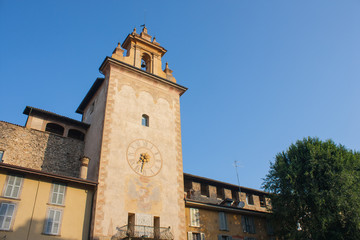Fototapeta na wymiar Bergamo - Old city. One of the beautiful city in Italy. Lombardy. The clock tower close to Roncalli historical building during a wonderful blue sky