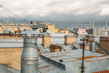 Obraz premium Old ventilation pipe on the roof of the apartment building