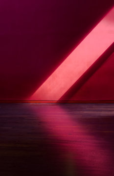 Ray of sunlight falling against a red wall